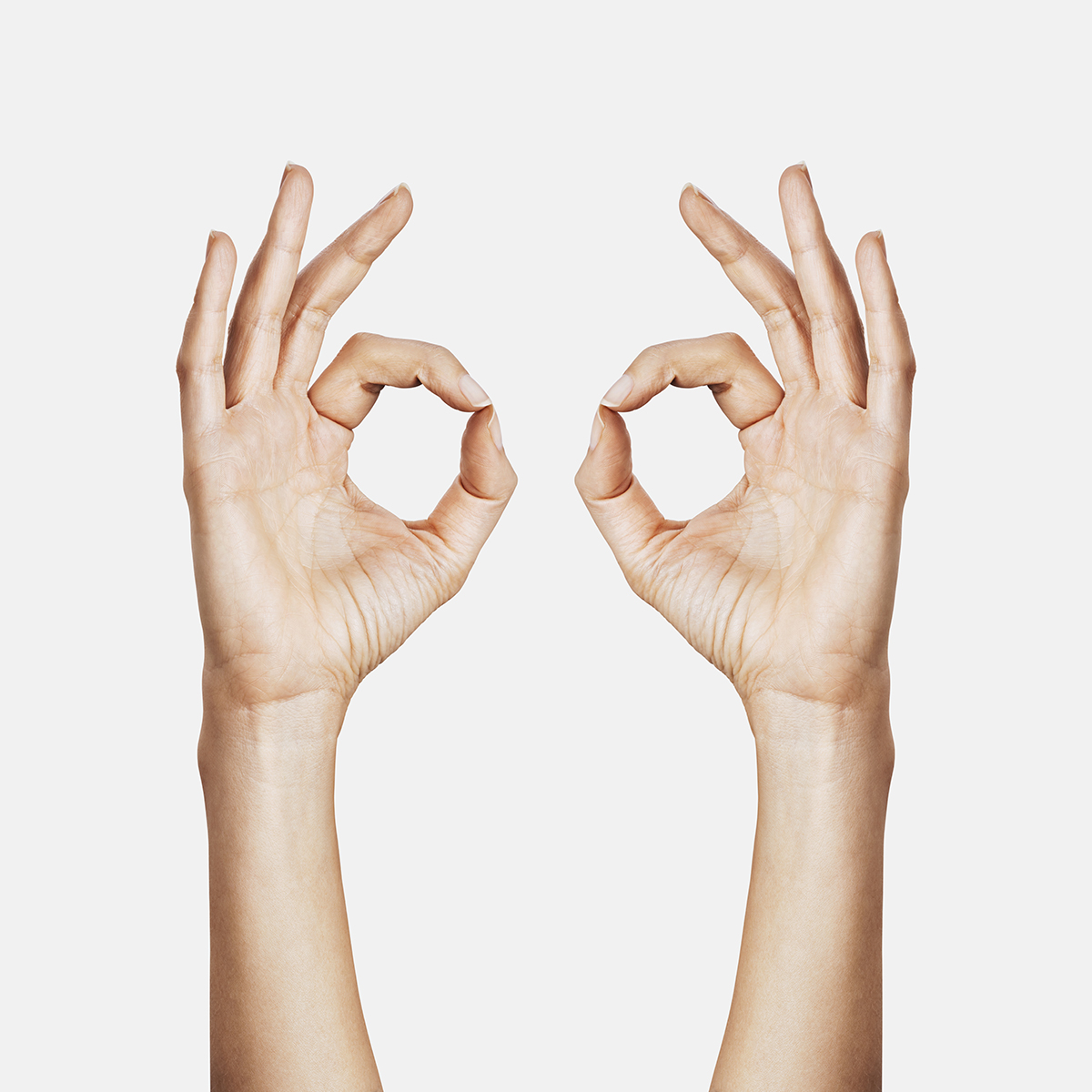 Two hands doing the OK hand sign