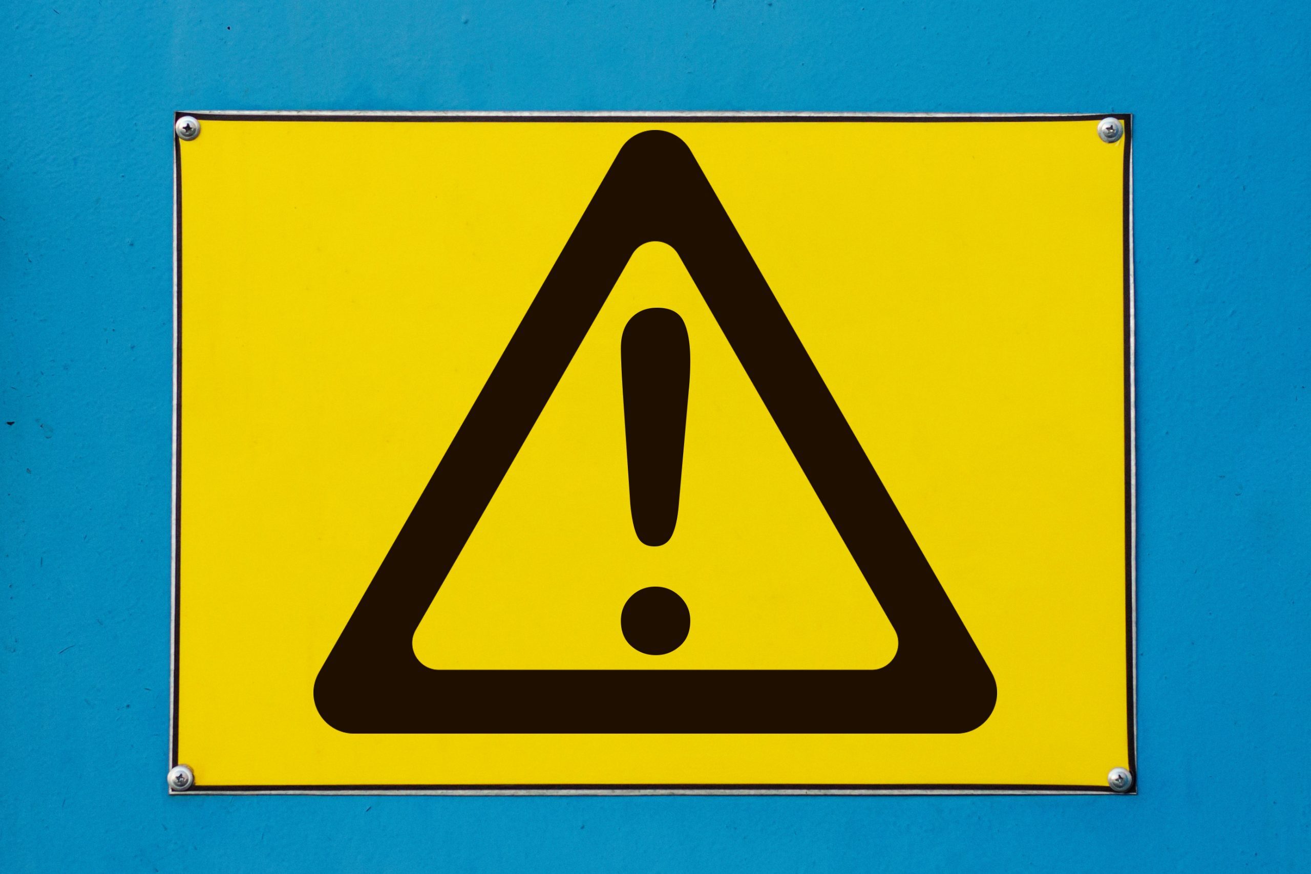 Yellow warning sign on blue background