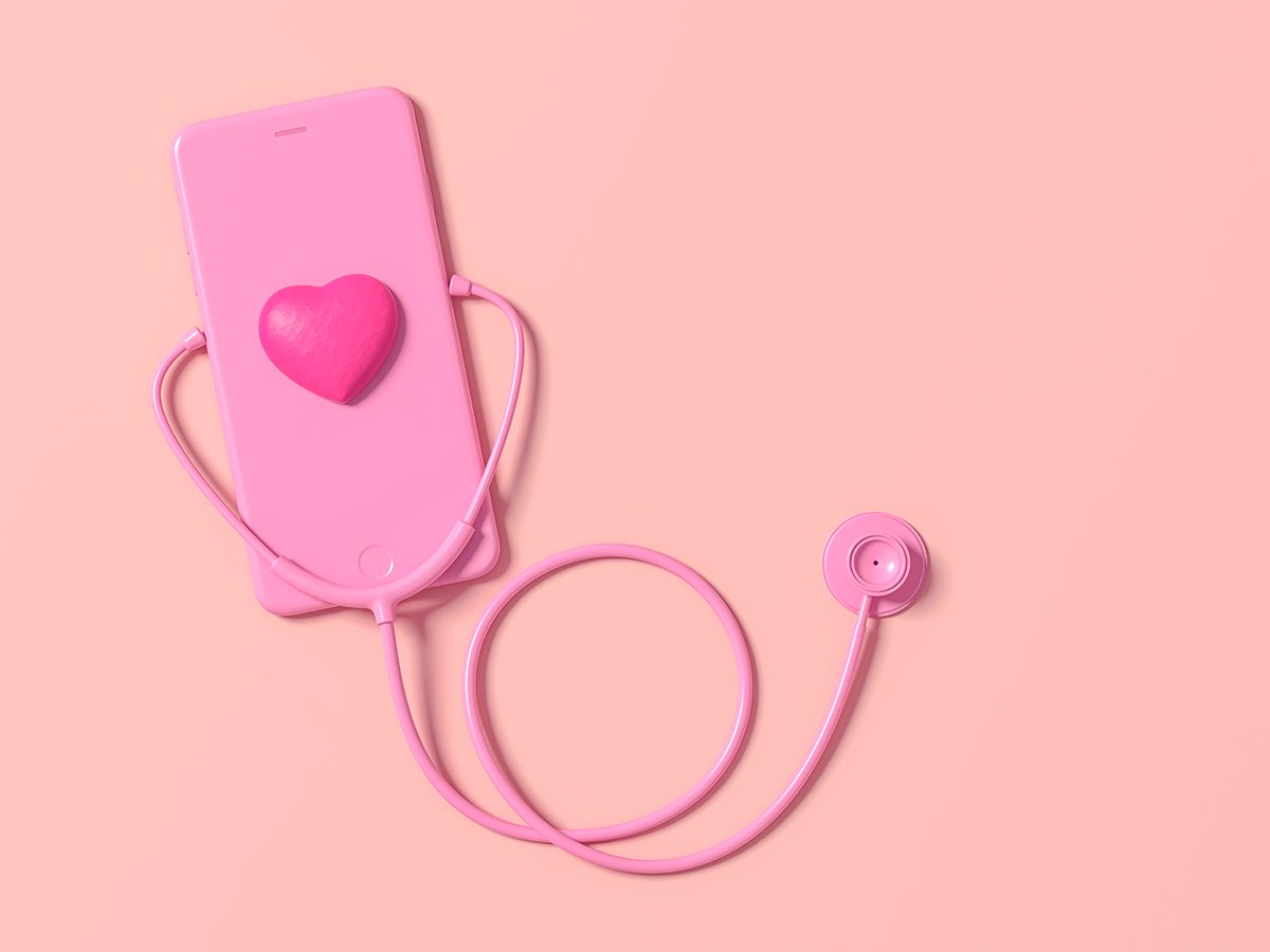A pink stethoscope is connected to a pink phone with a heart on the screen
