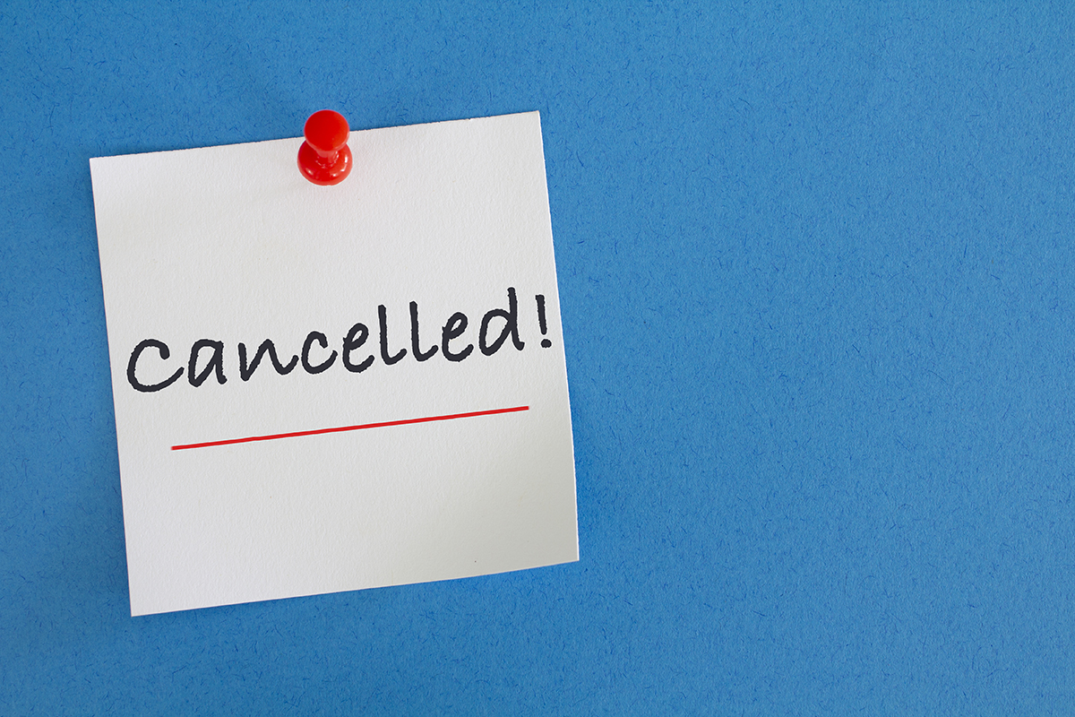 A white note that reads 'Cancelled!' is pinned to a blue background