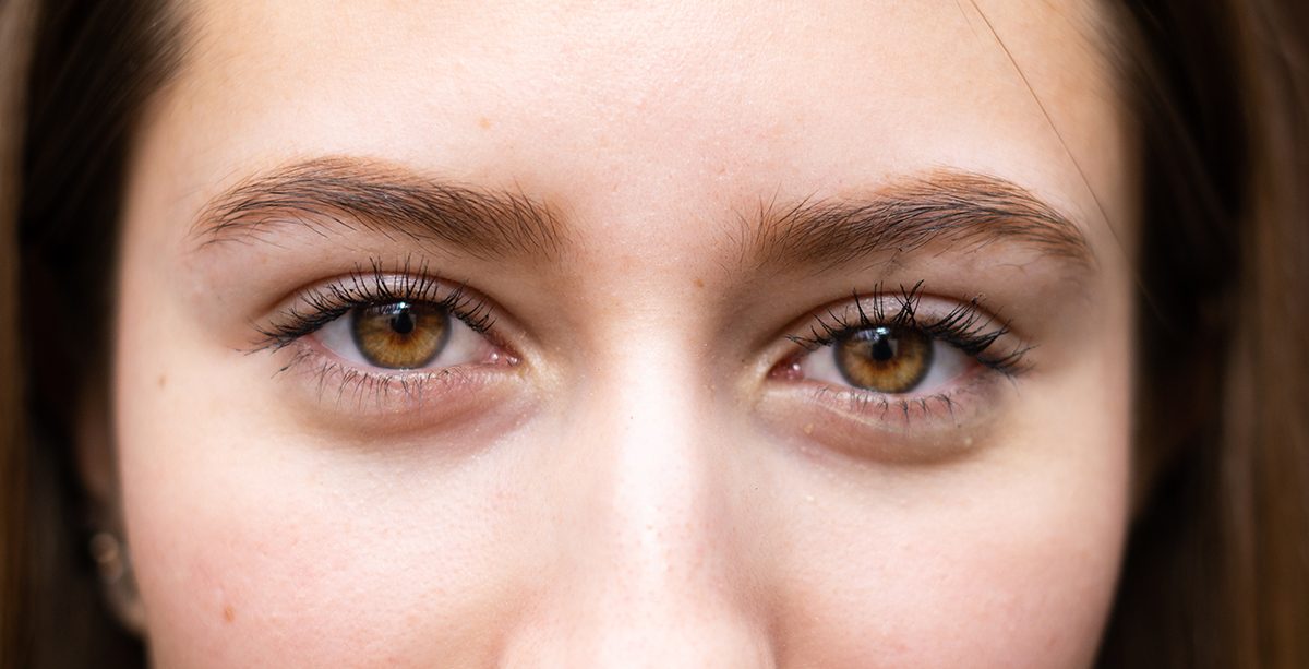 A close-up of a woman with brown eyes
