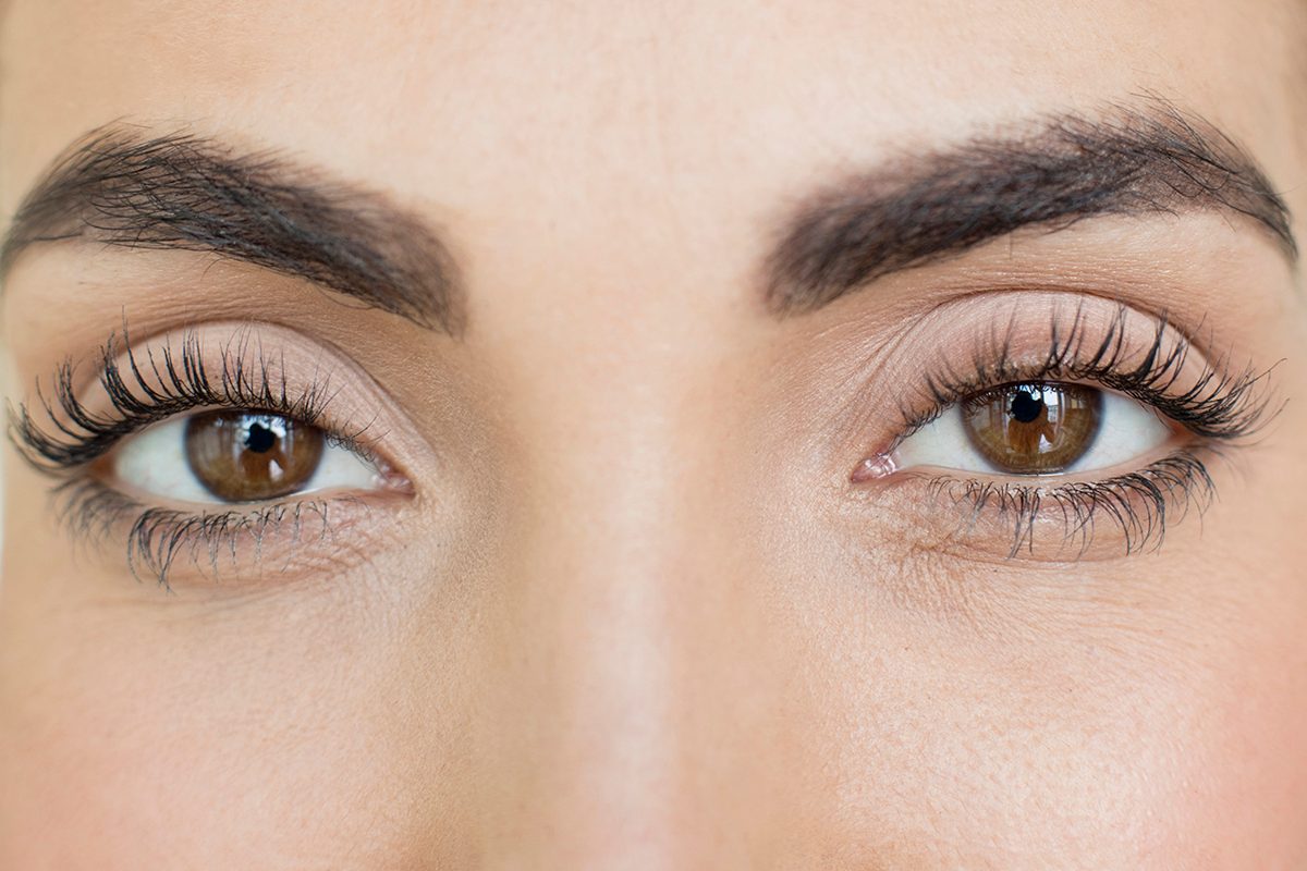 An extreme close-up of a woman with brown eyes