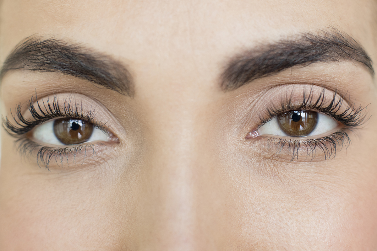 An extreme close-up of a woman with brown eyes