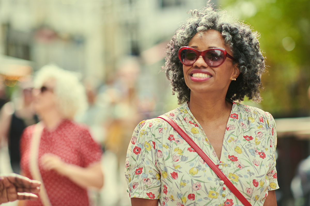 A woman wearing sunglasses in an outdoor setting