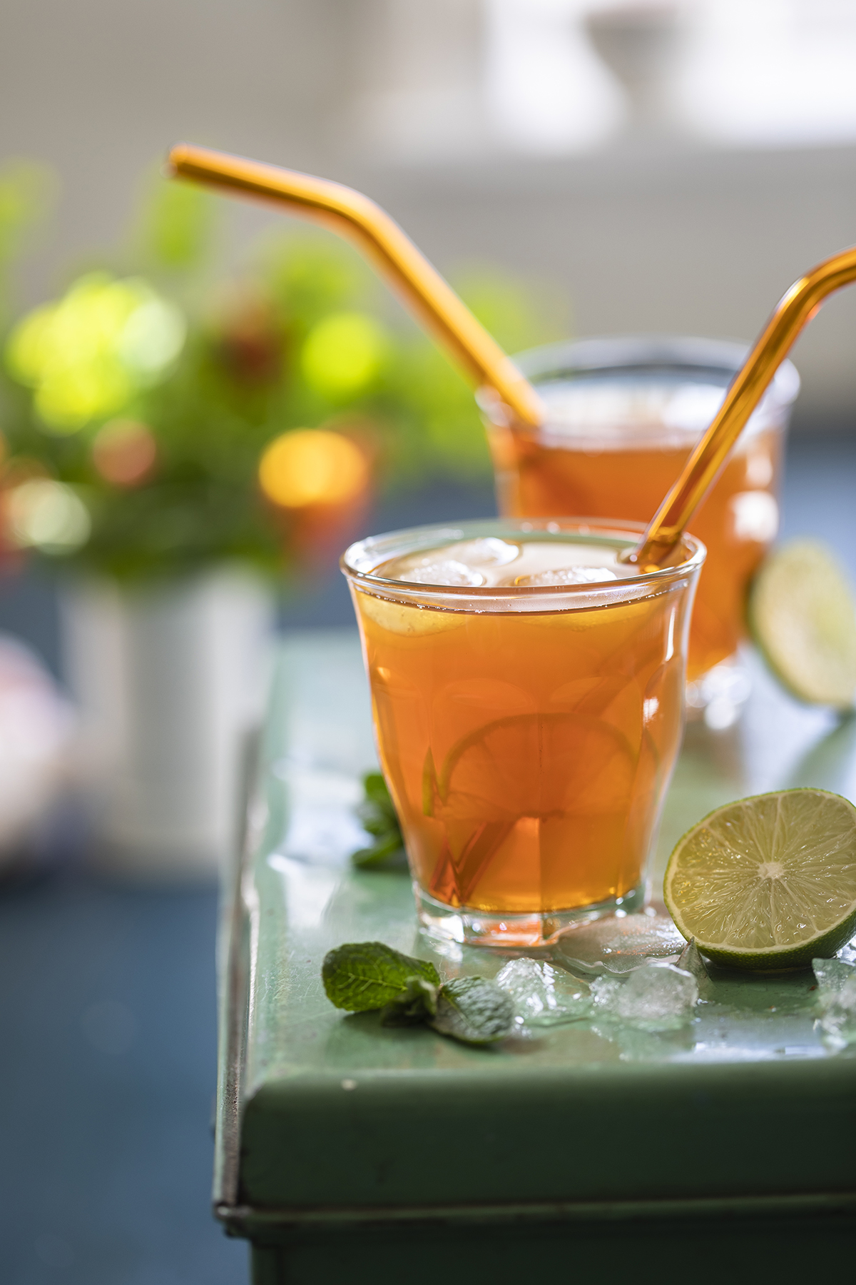 Two glasses of kombucha with orange straws