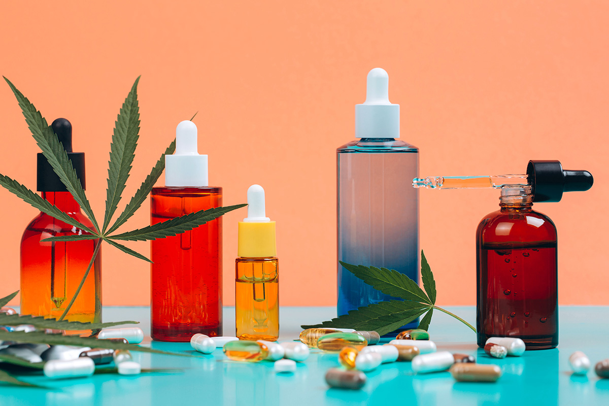 CBD oils and supplements are arranged against an orange and blue background
