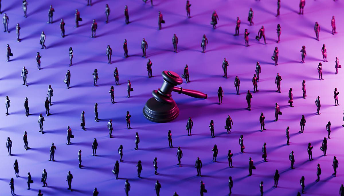 A towering justice gavel stands prominently at the center, illuminated by a dramatic blend of blue and purple lighting. Scattered across the scene are monochrome silhouettes of business professionals, positioned in varied stances.