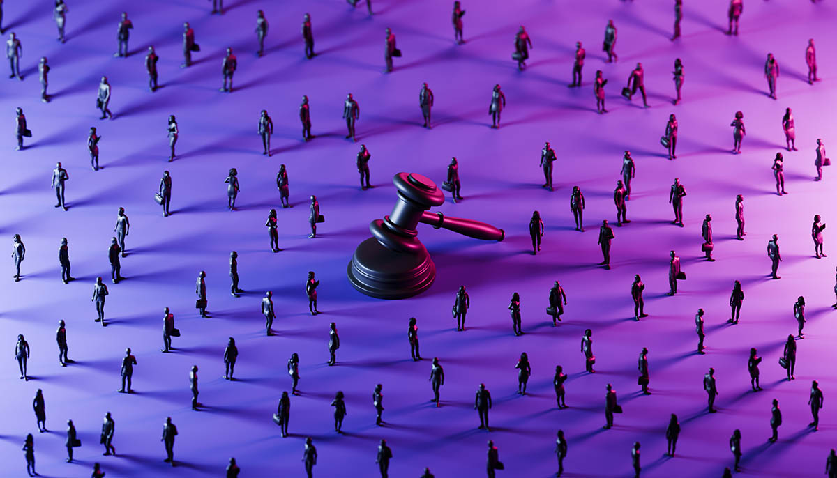 A towering justice gavel stands prominently at the center, illuminated by a dramatic blend of blue and purple lighting. Scattered across the scene are monochrome silhouettes of business professionals, positioned in varied stances.