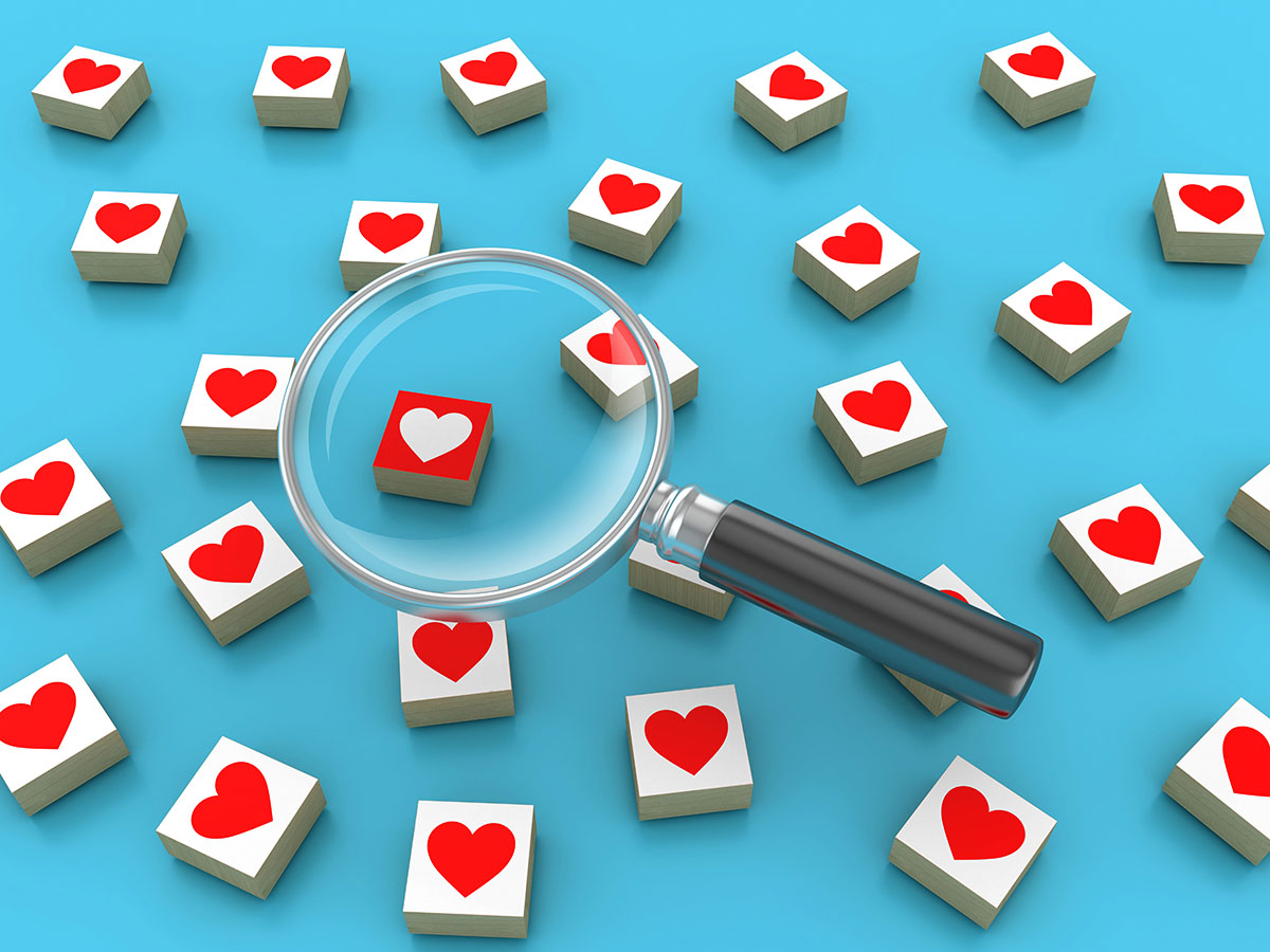 Blocks featuring hearts sit on a blue background, with a magnifying glass placed over one block