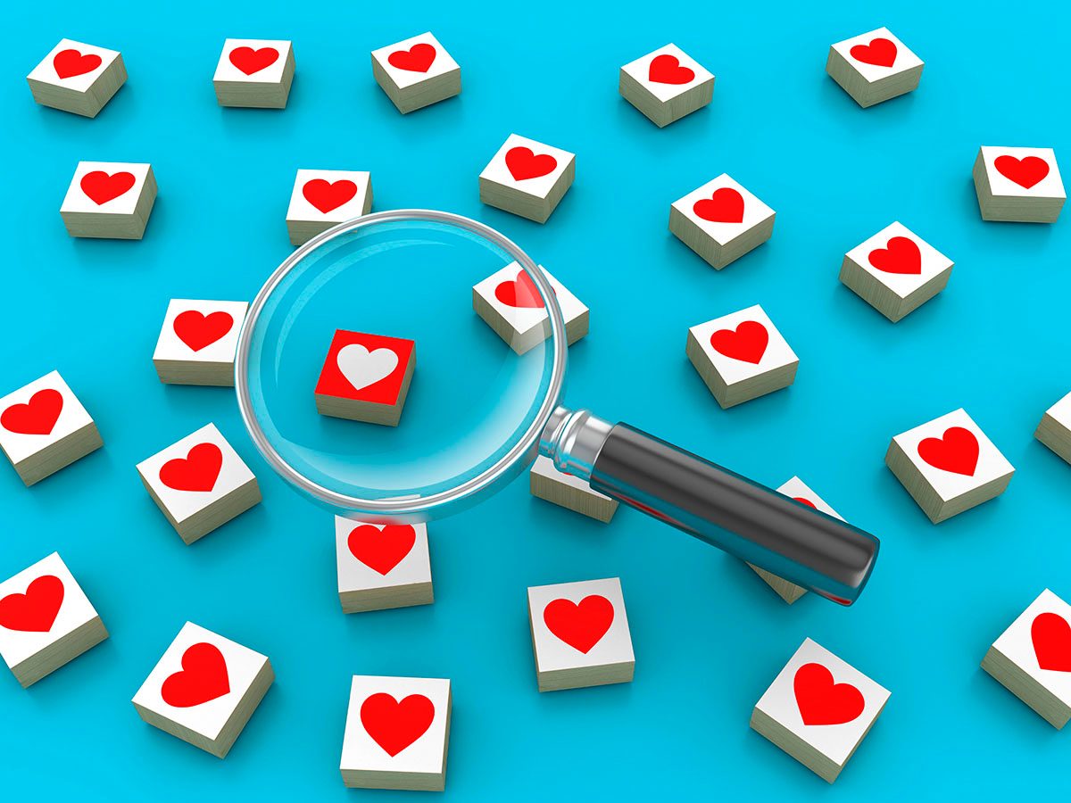 Blocks featuring hearts sit on a blue background, with a magnifying glass placed over one block