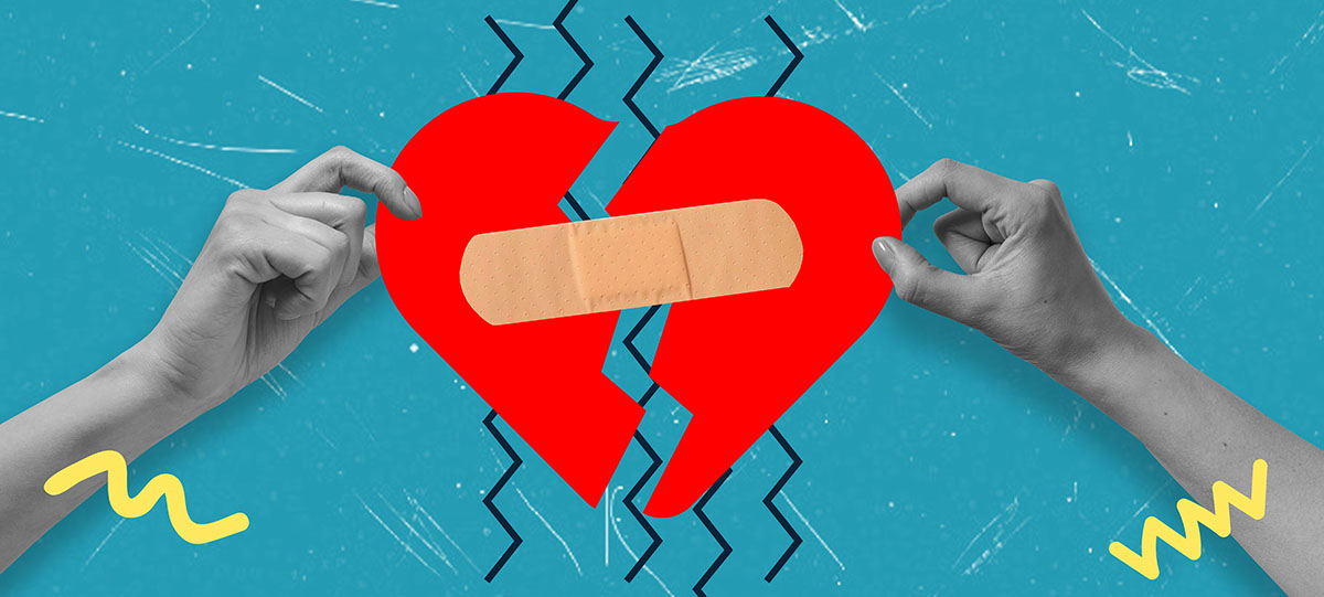 Two hands hold up two halves of a broken heart, which are joined by a plaster