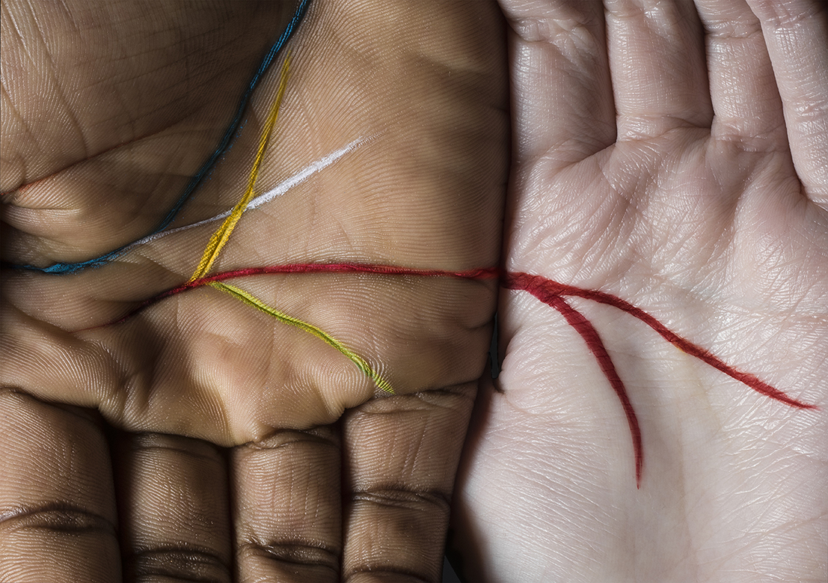 Two hands with the main lines marked in colourful pen