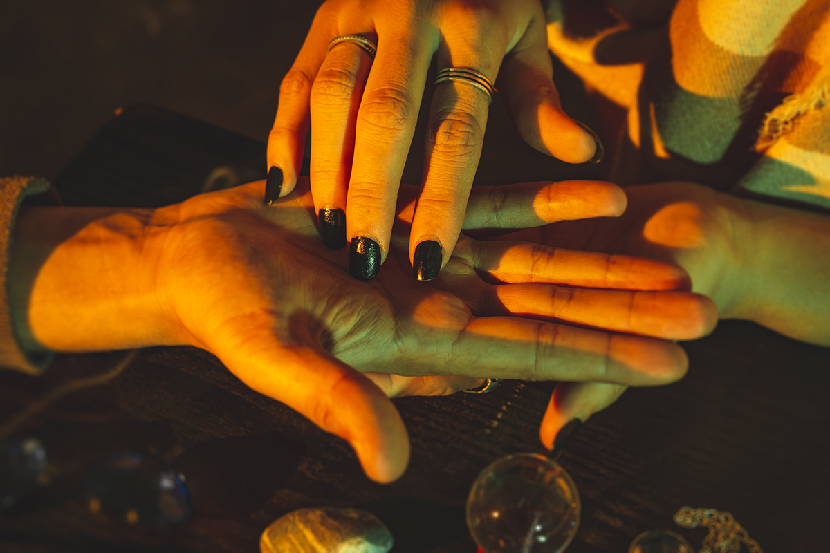 A close-up of a palm reading in a warm light