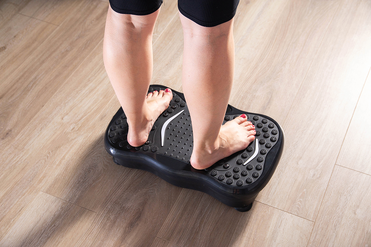 Woman standing on vibration plates