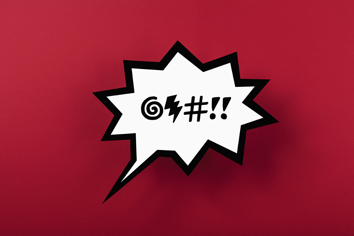 A speech bubble featuring symbols to represent swearing, against a red background