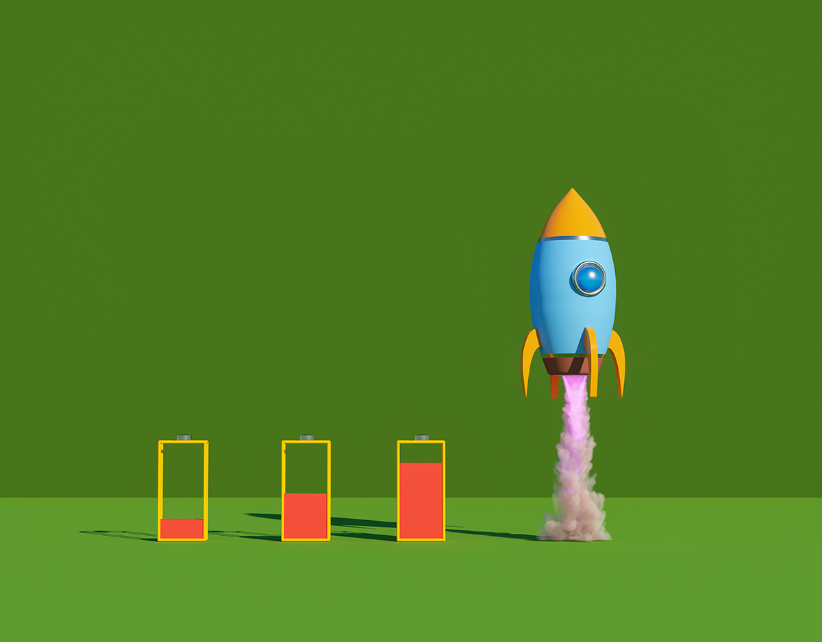 A cartoonish rocket takes off, leaving a trail of pink smoke, against a green background. Three battery icons with different red fill levels are lined up beside it.