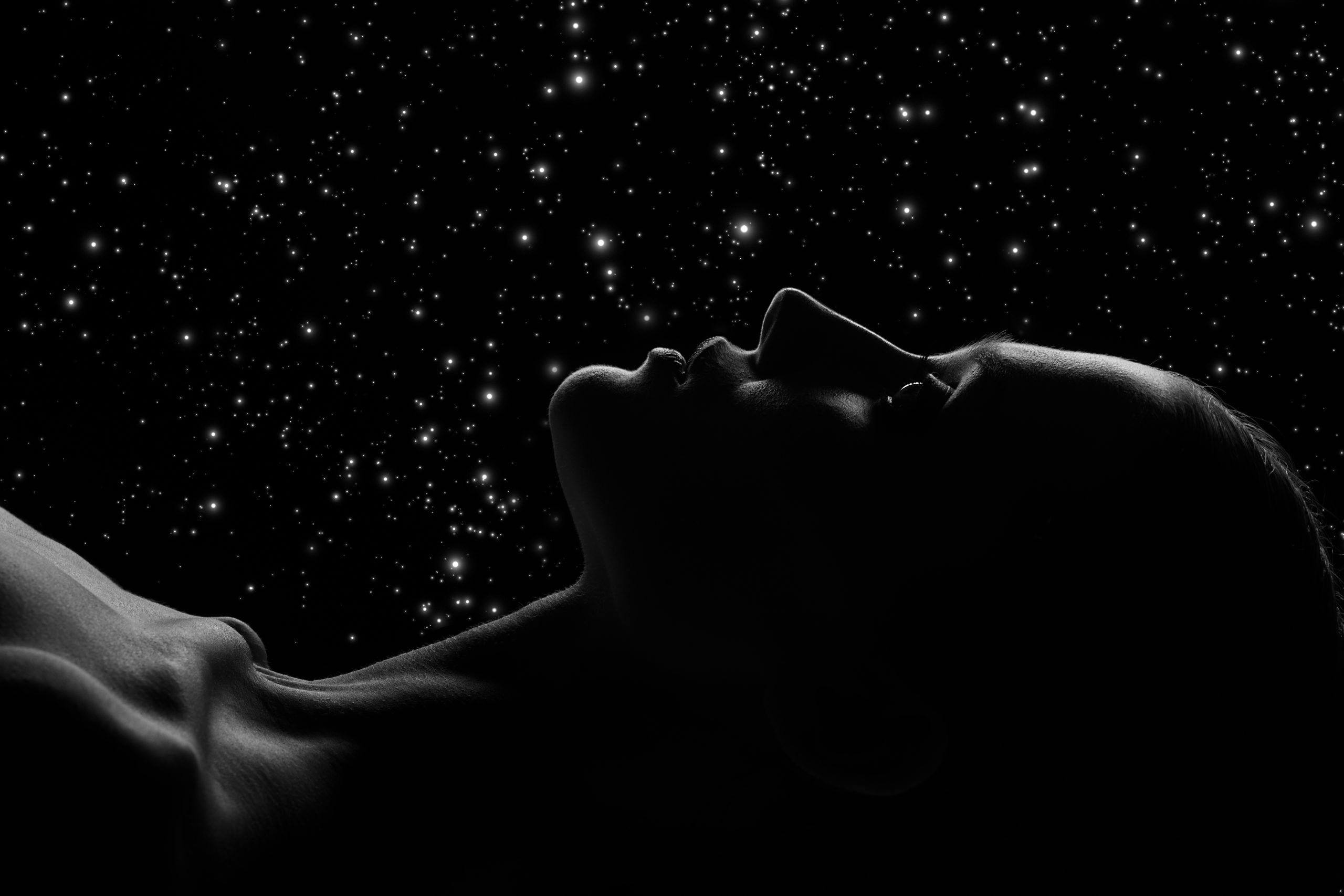 Woman lying down against a starry background