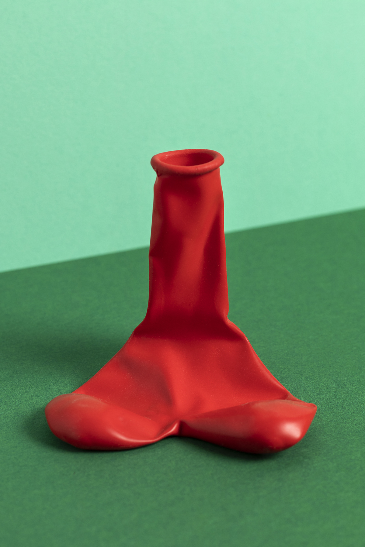 A phallic-shaped, deflated red ballon