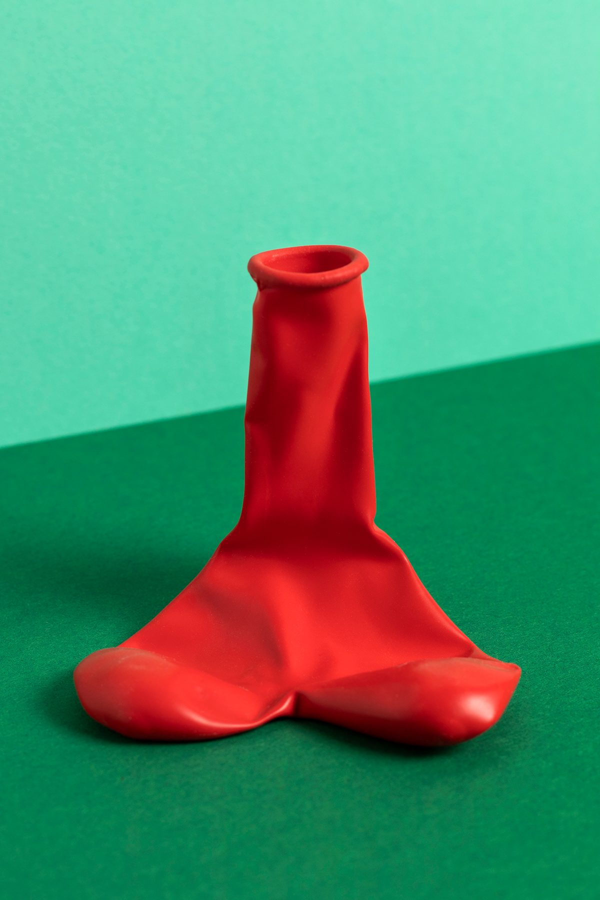 A phallic-shaped, deflated red ballon