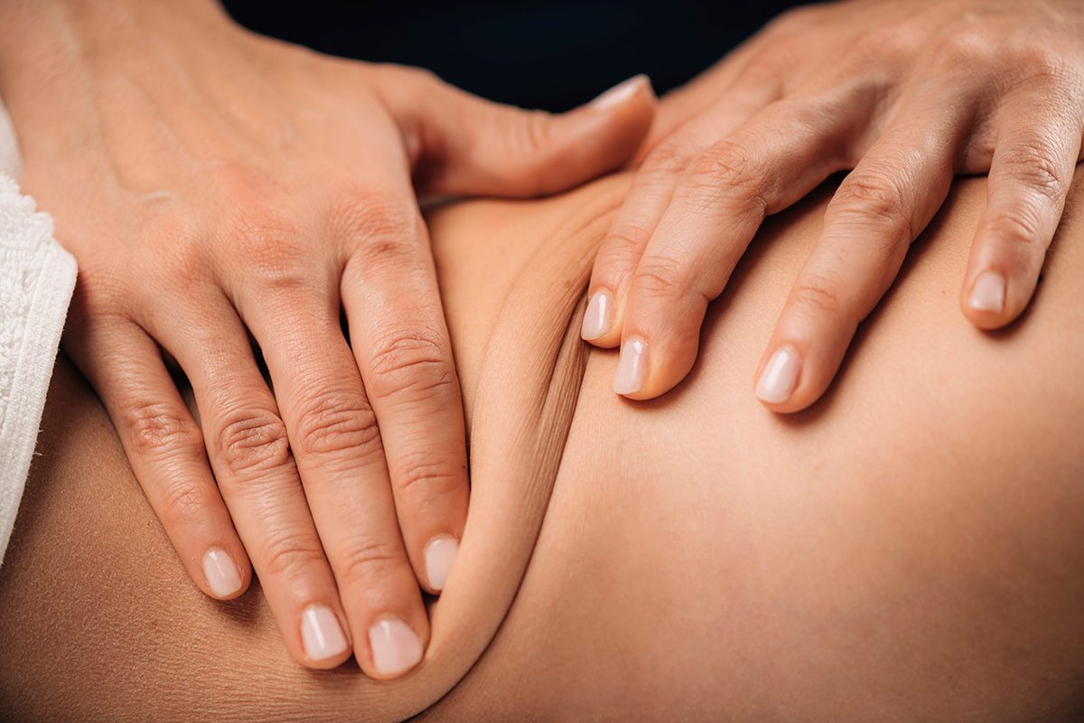 A close-up of a woman giving a client a deep tissue massage