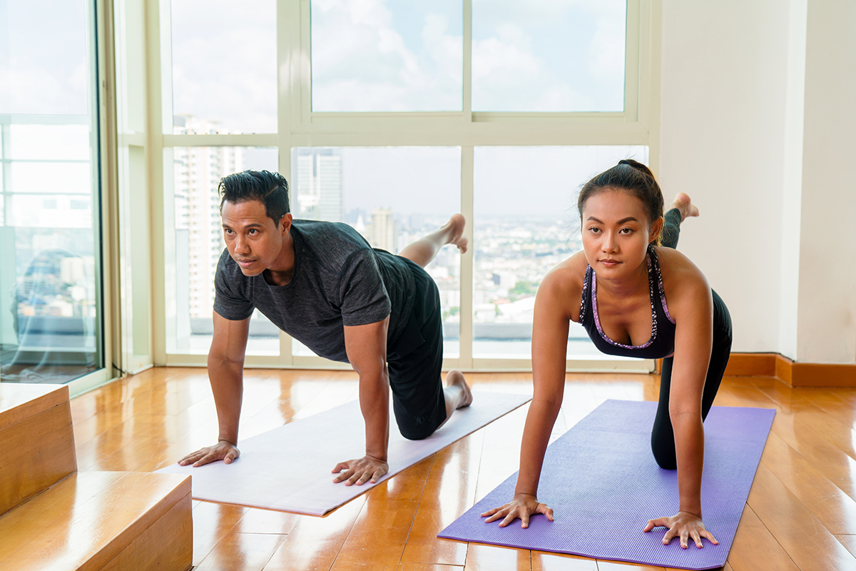 A couple doing pilates at home