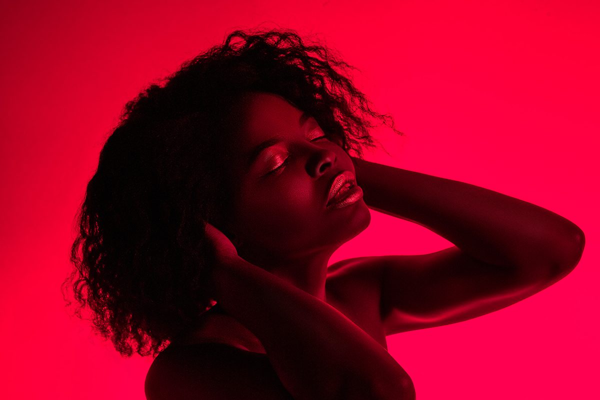 A woman wearing headphones in red light