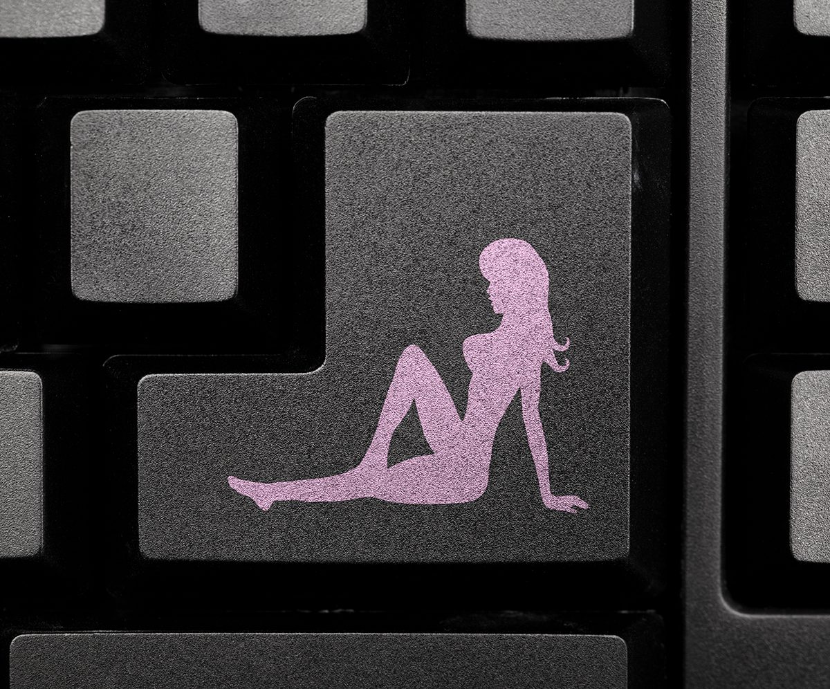 A computer keyboard key featuring an icon of the shape of a woman