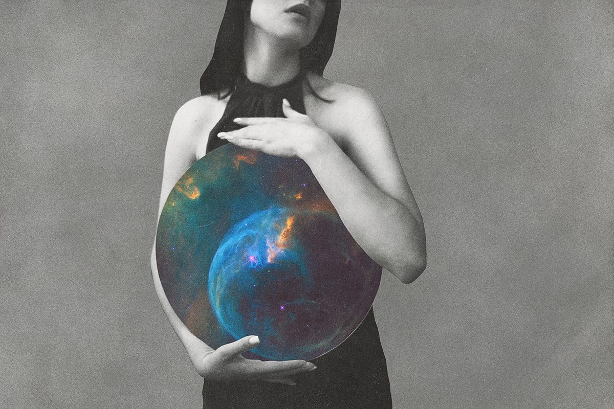 A black-and-white image of a woman holding a circle featuring a galaxy against her body
