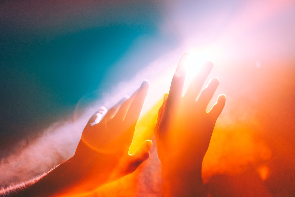 Hands reach towards the sun