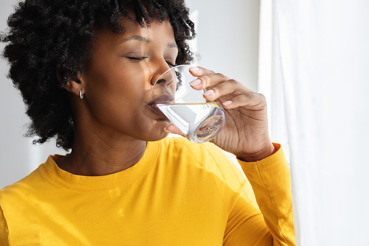 A woman drinking a glass of water