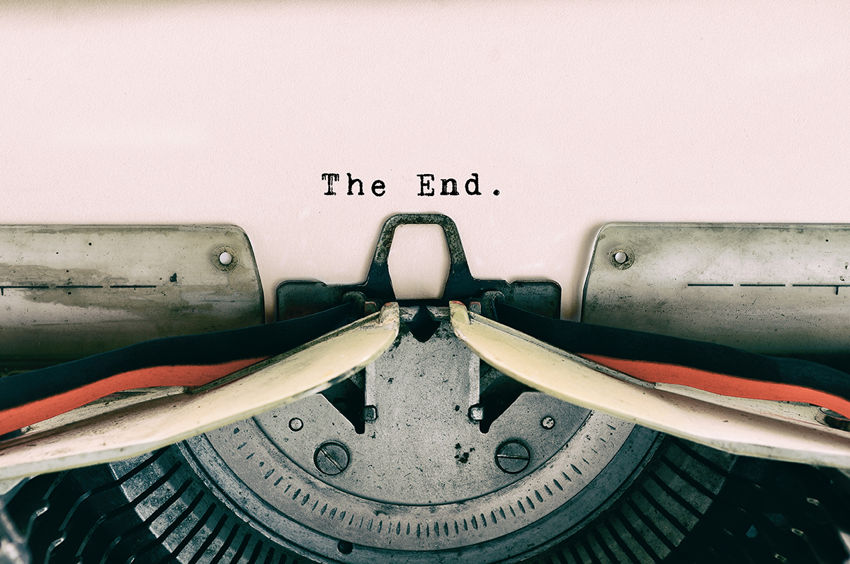A close-up shot of a typewriter with the words "The End" typed on paper is shown.