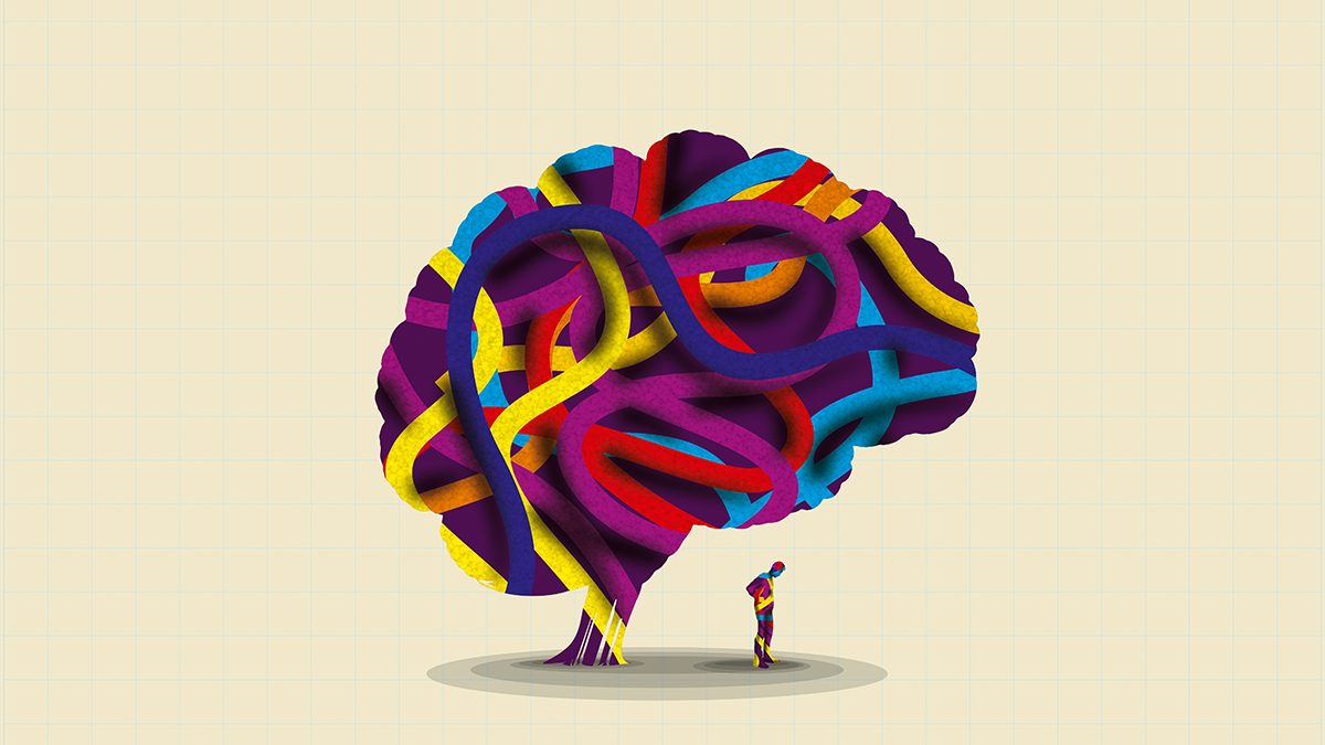A conceptual image of a small figure standing next to a large brain, both made from colourful strands