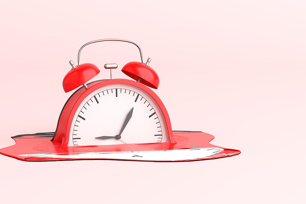 A 3D illustration of a red alarm clock melting.