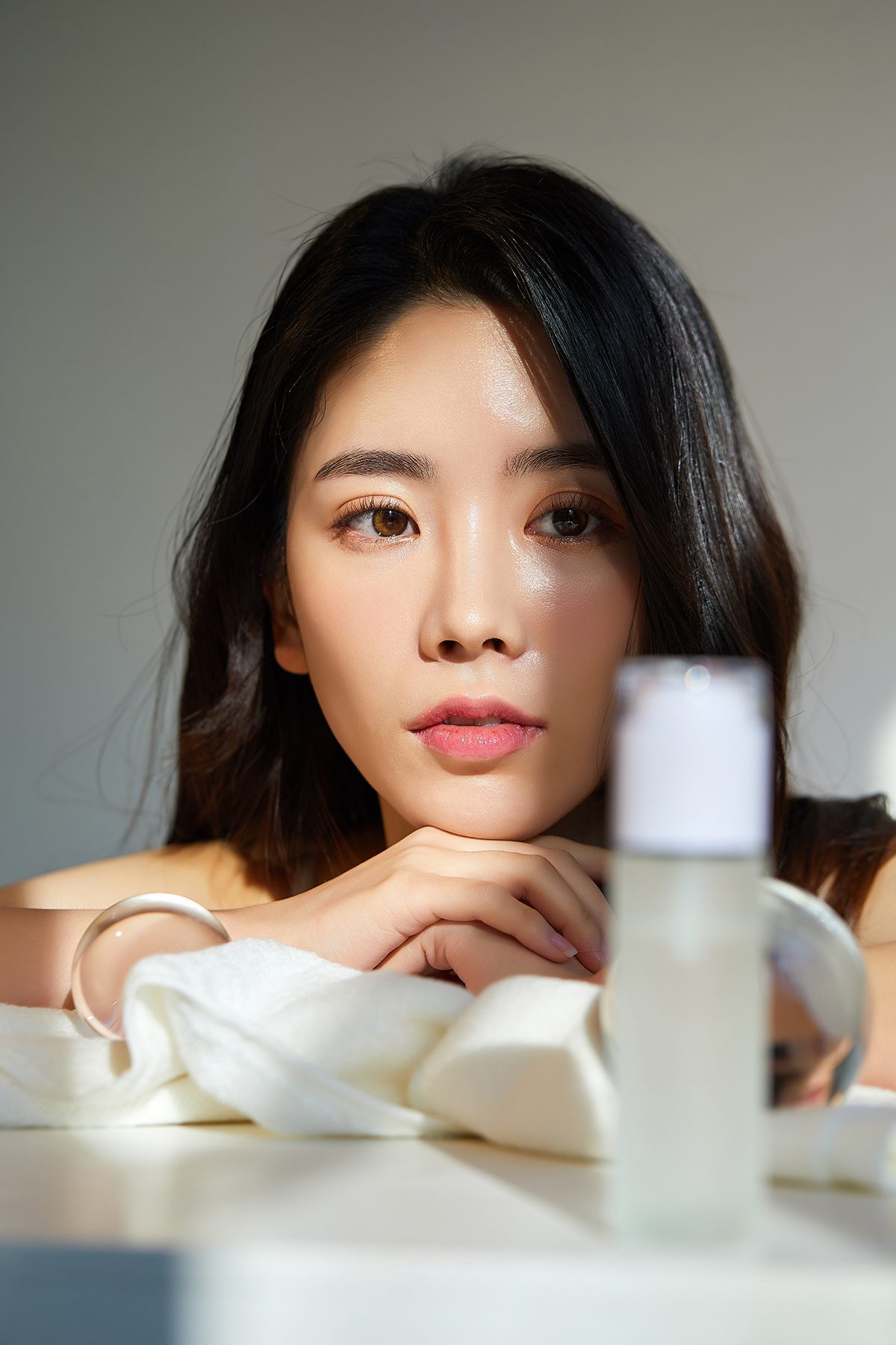 A woman looking at a cosmetic product