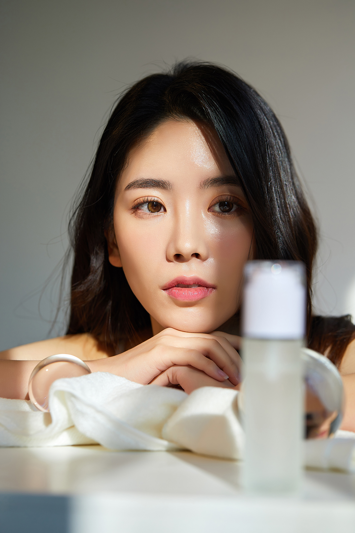 A woman looking at a cosmetic product