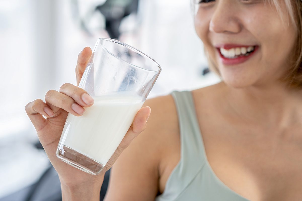 A woman drinking a glass of milk