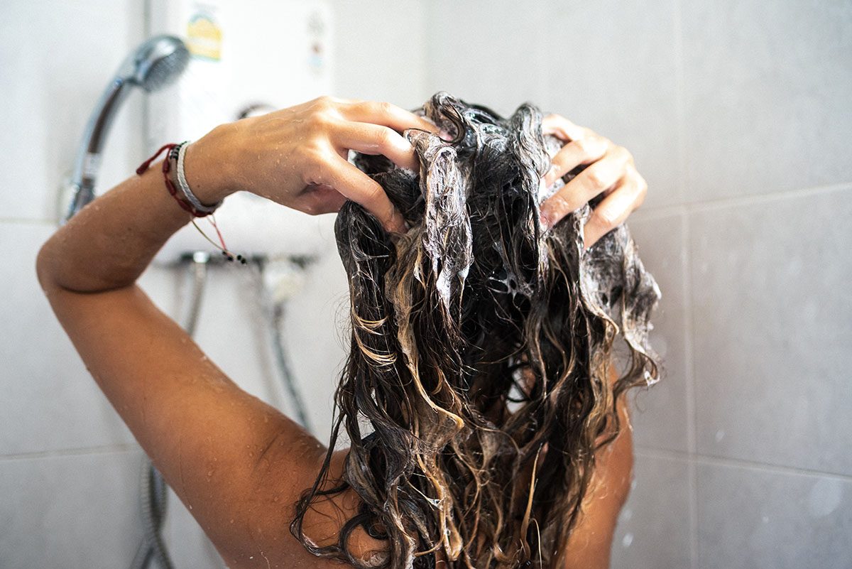 A woman washing her hair in the shower