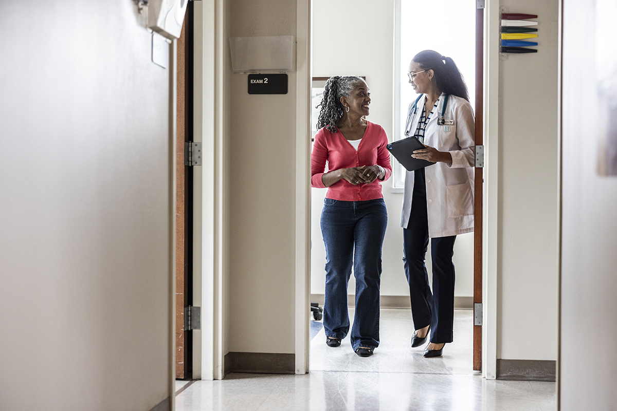 A woman talking to a female doctor in a GP surgery
