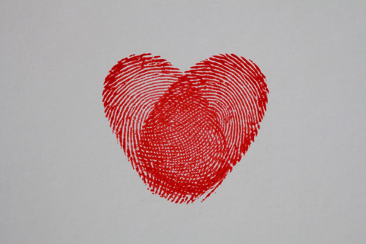 Two red thumbprints forming a heart