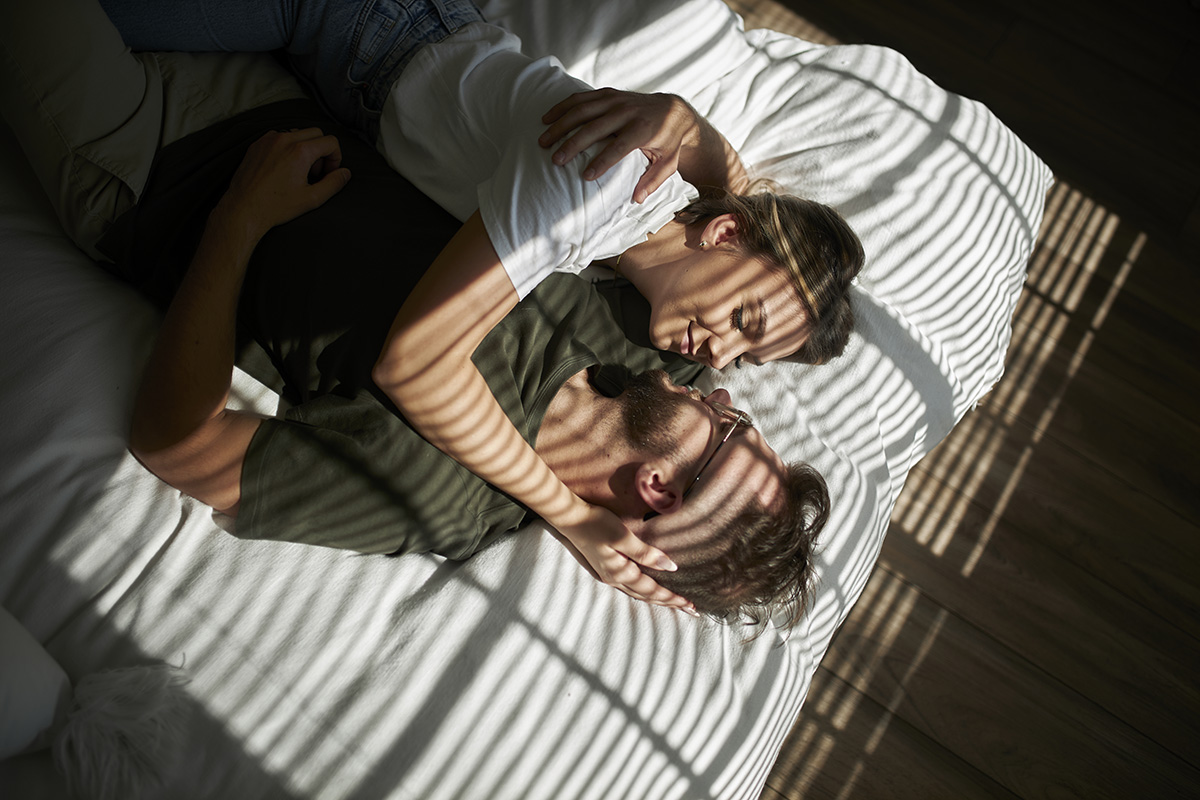 A couple hugging on a bed