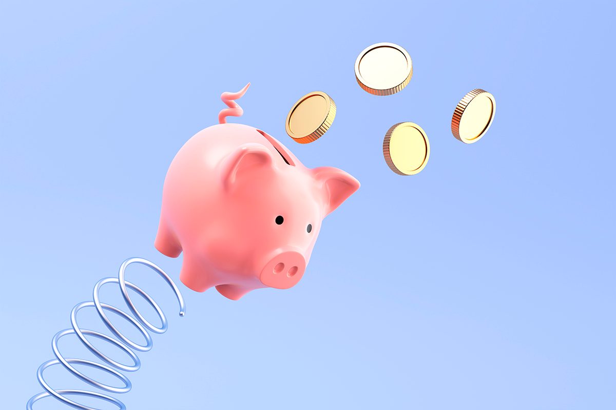 A piggy bank is launched from a spring, with coins falling from its slot, against a pale blue background