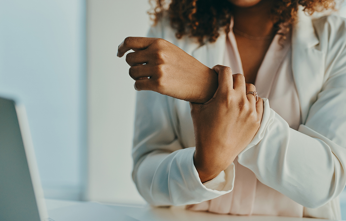 A woman holding her wrist