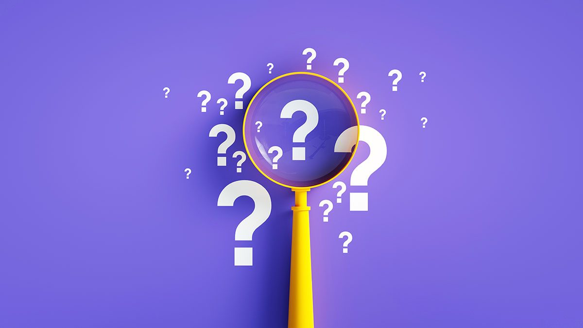 A yellow magnifying glass focuses on white question marks arranged in a cluster in the centre of a purple background