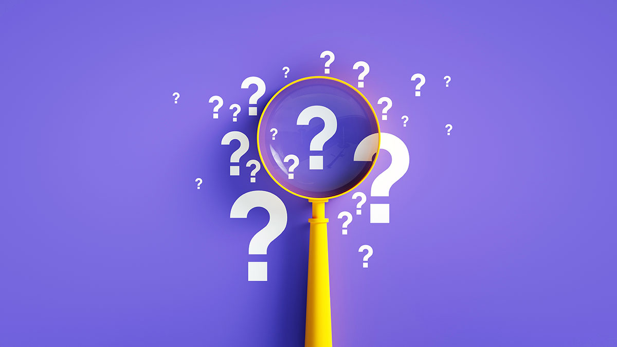 A yellow magnifying glass focuses on white question marks arranged in a cluster in the centre of a purple background