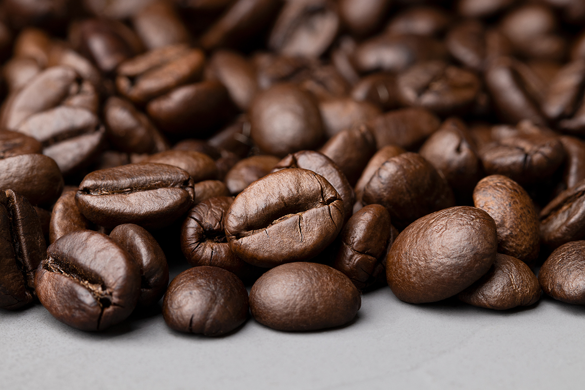 Coffee beans on a grey surface
