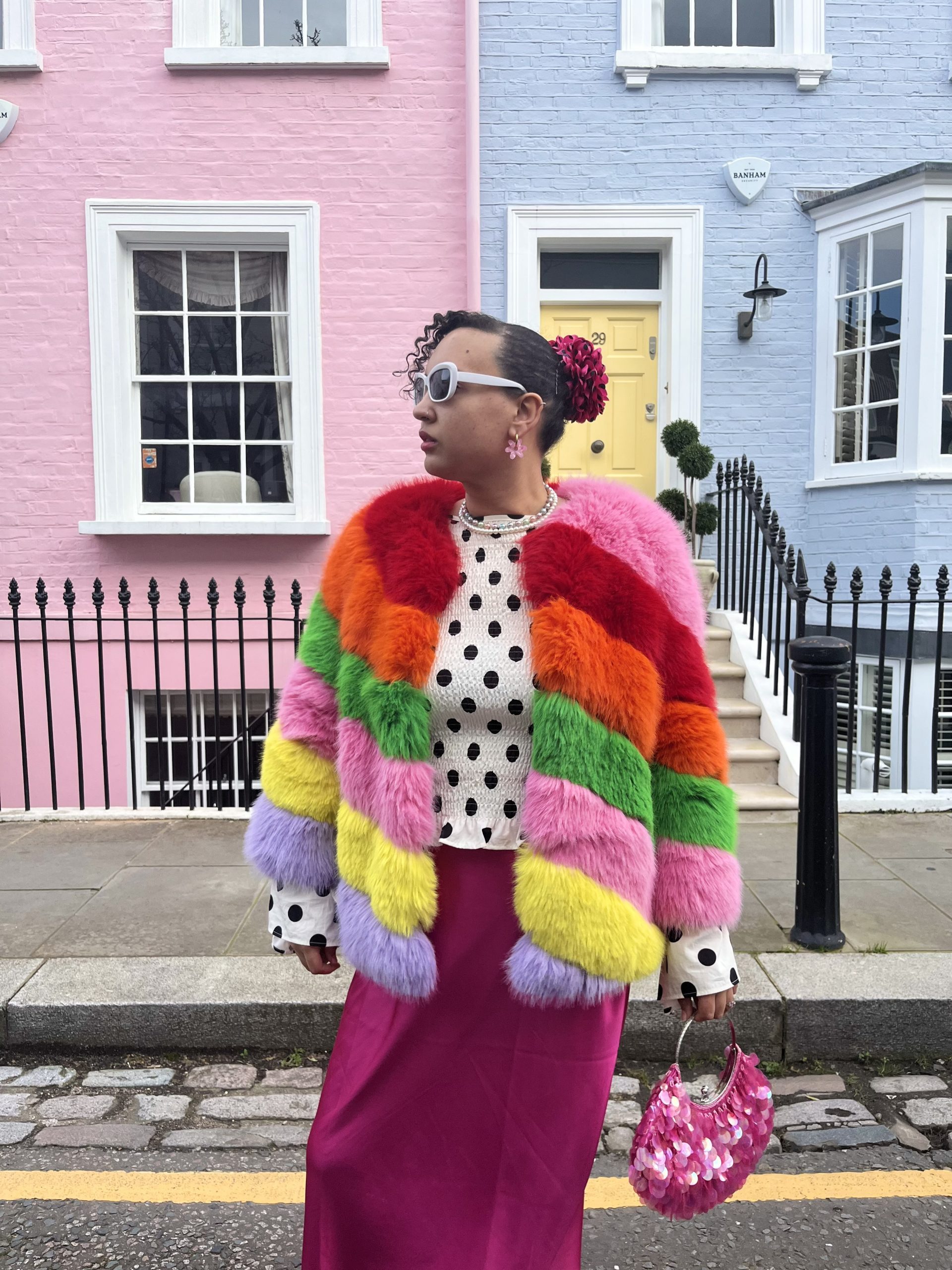 Women dressed in bright rainbow fur coat