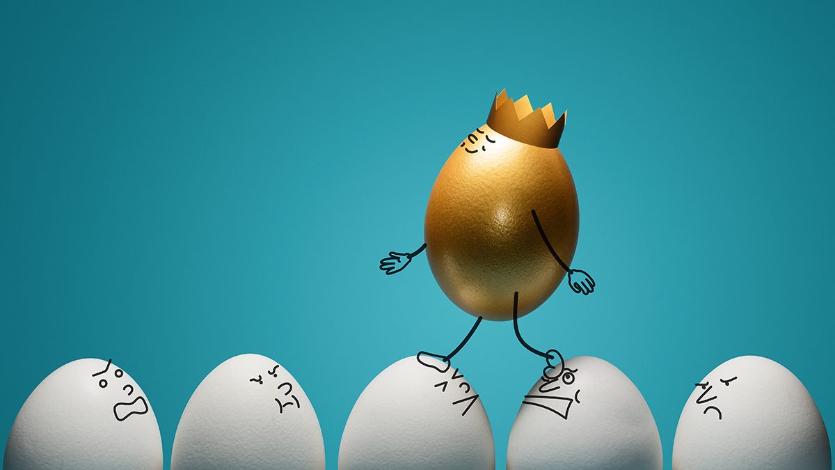 A golden egg wearing a crown is walking over white eggs