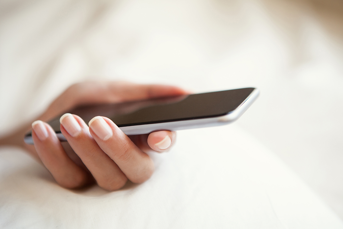 A female hand holding a smartphone