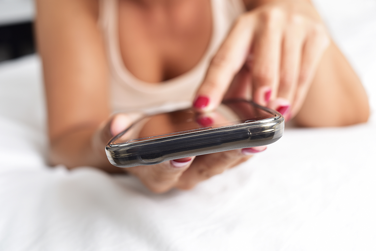 A woman typing on her phone