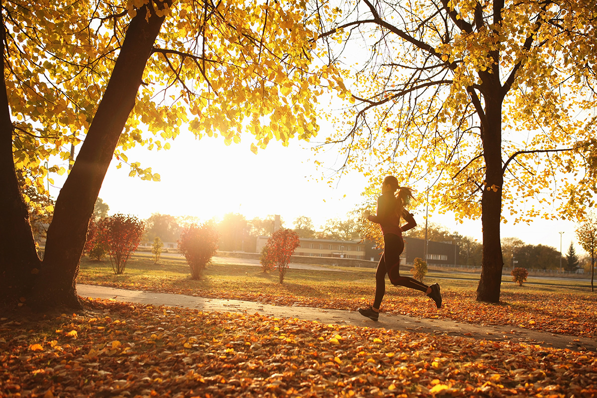 A woman running in an autumnal park